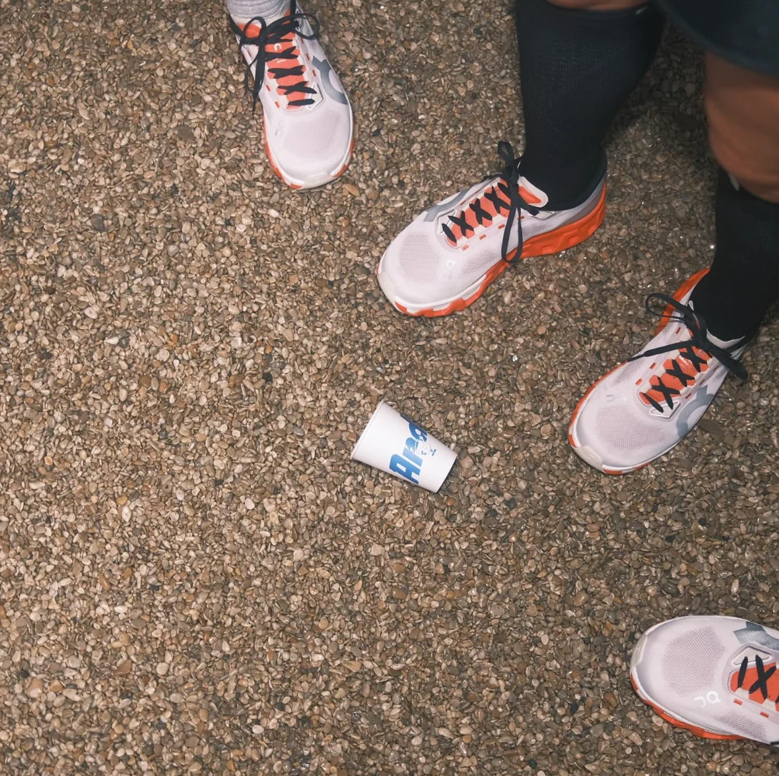 Runners lacing up their shoes before an Andy's Runners Club interval session in Berchem
